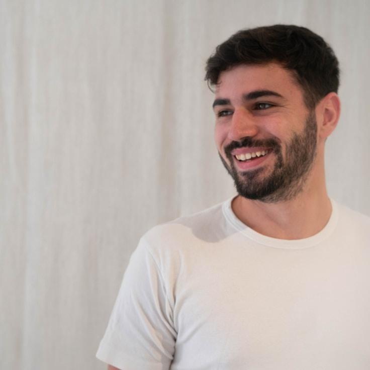 Alex Chen, Lead Design Strategist at LedgerFrameHub, reviewing corporate floral arrangements